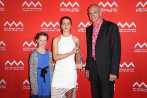 SYDNEY, AUSTRALIA - AUGUST 26:  Dr Karl Kruszeinicki (R) presents Paige Bebee with first place in the 'University of Sydney Sleek Geeks Science Eureka Prize - Secondary' as Milla Bebee looks on at the Australian Museum Eureka Prizes 2015 at Sydney Town Hall on August 26, 2015 in Sydney, Australia.  (Photo by Brendon Thorne/Getty Images)