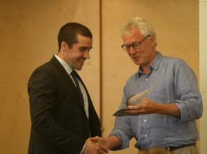 Geoff Faulknre accepts his award from Neil Lawrence