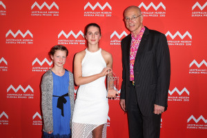SYDNEY, AUSTRALIA - AUGUST 26: Dr Karl Kruszeinicki (R) presents Paige Bebee with first place in the 'University of Sydney Sleek Geeks Science Eureka Prize - Secondary' as Milla Bebee looks on at the Australian Museum Eureka Prizes 2015 at Sydney Town Hall on August 26, 2015 in Sydney, Australia. (Photo by Brendon Thorne/Getty Images)