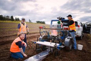 Mr Andrew Makin, and co. working on the direct seeder with the degradable polyolefin film