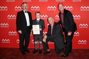 SYDNEY, AUSTRALIA - AUGUST 26: Trevor Hambley, Dean of Science University of Sydney, Dr Karl Kruszelnicki and Adam Spencer present William Martin (c) of Trinity Grammar Sydney with second place in the 'University of Sydney Sleek Geeks Science Eureka Prize - Primary' at the Australian Museum Eureka Prizes 2015 at Sydney Town Hall on August 26, 2015 in Sydney, Australia. (Photo by Brendon Thorne/Getty Images)