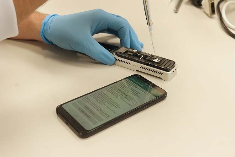 Hand doing a test next to phone