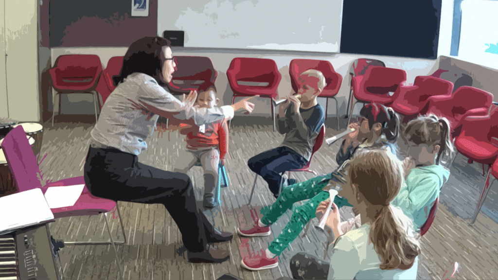 A music tutor leads a small group of children in a circle blowing small horns.