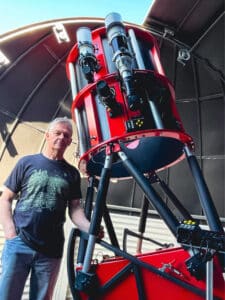 Plumber and award-winning amateur astronomer Rod Stubbings pictured with his telescope. 