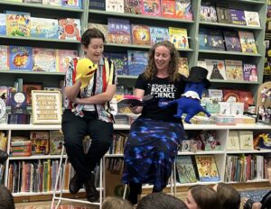 Two people in library with puppets